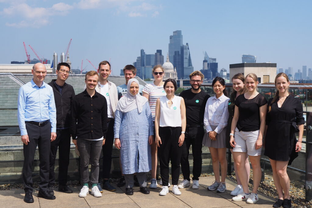 Group picture on the rooftop with London skyline in the background